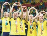 ?? TERTIUS PICKARD/AP ?? Sweden gesture to supporters as they celebrate with their bronze medals after beating Australia in the World Cup on Saturday in Brisbane, Australia.