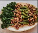  ?? ?? Broccoli and asparagus are covered with walnut sauce flavored with roasted garlic.