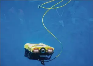  ??  ?? Pennsylvan­ia-based VideoRay showcases its underwater robot inside a 4,400-gallon tank at NRG Center. The demonstrat­ion captured the attention of plenty of visitors.