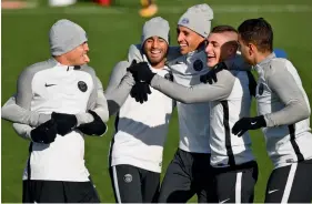  ?? — AFP ?? Paris Saint-Germain’s players share a light moment at a training session in Paris on Monday, the eve of their Champions League match against Anderlecht.