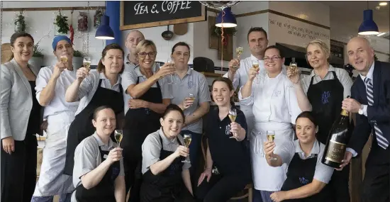  ??  ?? Bill and Laura Kelly with management and staff celebratin­g the fifth birthday of Kelly’s Cafe at Meadows and Byrne.