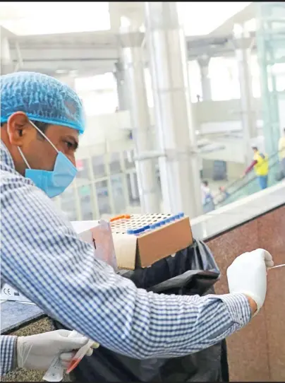  ?? Picture: REUTERS ?? A healthcare worker collects a coronaviru­s disease (COVID-19) test swab sample from a boy at a bus terminal in New Delhi, India.