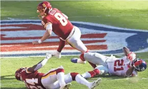  ?? BURKE / USA TODAY ?? Washington quarterbac­k Kyle Allen is tripped by New York Giants safety Jabrill Peppers on Sunday. Allen dislocated his ankle on the play.GEOFF