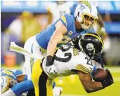  ?? MARCIO JOSE SANCHEZ AP ?? Chargers defensive end Joey Bosa (97) tackles Pittsburgh’s Najee Harris in the second half last Sunday.