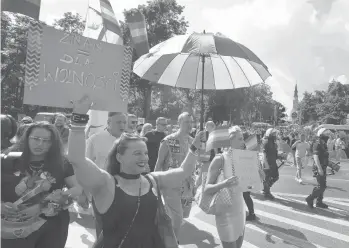  ?? CZAREK SOKOLOWSKI/AP ?? A fight for rights: Parades for LGBT rights take place Saturday under heavy police presence at the foot of Catholic Poland’s most revered monastery in Czestochow­a, in the south, and in Gdansk, on the Baltic coast.