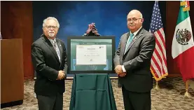  ?? Submitted photo ?? ■ Dr. Jose Romero recently received the Ohtli Award from Rodolfo Quilantan Arenas from the Mexican Consulate in Little Rock.