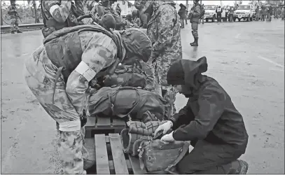  ?? RUSSIAN DEFENSE MINISTRY PRESS SERVICE VIA AP ?? In this photo taken from video released by the Russian Defense Ministry on Thursday, Russian servicemen frisk Ukrainian servicemen after they leave the besieged Azovstal steel plant in Mariupol in eastern Ukraine.