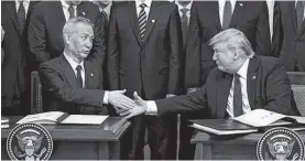  ?? REUTERS ?? Chinese Vice Premier Liu He and U.S. President Donald Trump shake hands after signing “phase one” of the U.S.-China trade agreement during a ceremony in the East Room of the White House in Washington, U.S., January 15, 2020.