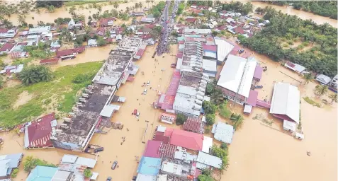  ??  ?? This aerial photo shows a general view of submerged buildings after heavy rain caused flooding in Bengkulu on the Indonesian island of Sumatra. — AFP photo