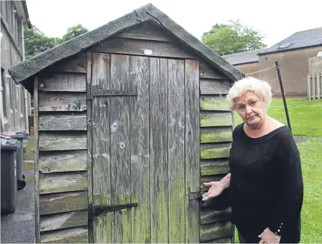  ??  ?? Margaret Barry is pictured next to her shed, which was being emptied by three men when she came home one day.