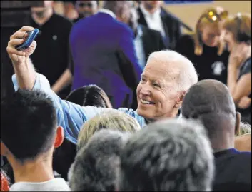  ?? Meg Kinnard The Associated Press ?? Former Vice President Joe Biden takes photos with supporters following the first rally of his 2020 campaign Saturday in Columbia, S.C.