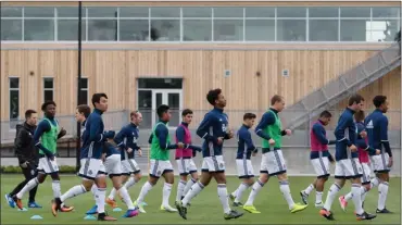  ?? The Canadian Press ?? Vancouver Whitecaps players run through drills during practice outside the MLS soccer team's new National Soccer Developmen­t Centre training facility at the University of British Columbia in Vancouver, B.C., on Wednesday.