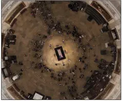  ?? AP/MORRY GASH ?? Former President George H. W. Bush lies in state in the U.S. Capitol Rotunda on Tuesday in Washington. A lifelong Episcopali­an, Bush is credited by some for helping move Republican­s toward conservati­ve Christiani­ty.