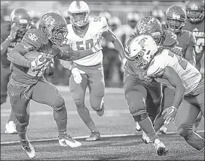  ?? Arkansas Democrat-Gazette/MITCHELL PE MASILUN ?? North Little Rock running back Brandon Thomas runs upfield as Little Rock Parkview linebacker Trevon Hadley closes in during Friday night’s game at North Little Rock.