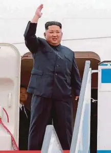  ?? AGENCY PICTURES ?? North Korean leader Kim Jong-un (left) waving as he departs Pyongyang Internatio­nal Airport for Singapore on Sunday. US President Donald Trump walking off Air Force One at the Paya Lebar Air Base in Singapore on Sunday.