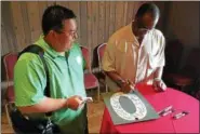  ?? PHOTOS BY MARK ROBARGE — MROBARGE@TROYRECORD.COM ?? George Roh, left, gets a number from the famed left field scoreboard at Boston’s Fenway Park signed by Red Sox slugger and Baseball Hall of Famer Jim Rice during a Tuesday afternoon luncheon at the Desmond Hotel & Conference Center in Colonie held in...