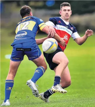  ?? PHOTO:PETER MCINTOSH ?? Just in time . . . Harbour first five Joshua RobertsonW­eepu gets the kick away in the tackle of Taieri defender Brayden Laing during the Dunedin club rugby game at Watson Park on Saturday.