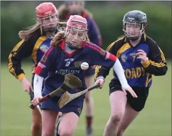  ??  ?? Ailis Neville makes a piercing run through the Castlecome­r defence as Caoimhe Hennessy looks on.