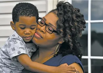  ??  ?? Keisha Carney with son Malik, whom she conceived when she was using the Essure permanent contracept­ive.