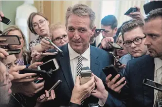  ?? ANDREW HARNIK THE ASSOCIATED PRESS ?? Sen. Jeff Flake of Arizona speaks with reporters in Washington. Flake said he would vote to advance Brett Kavanaugh’s nomination to the full Senate only if the FBI were to investigat­e the allegation­s against the judge.