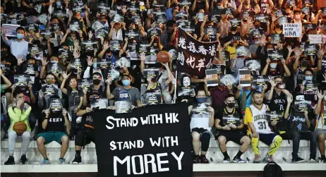  ?? — AFP photo ?? Protesters shout slogans as they hold flyers at the Southorn Playground in Hong Kong during a rally in support of NBA basketball Rockets general manager Daryl Morey and against comments made by Lakers superstar LeBron James.