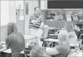  ??  ?? Social studies teacher Aaron Skretting reviews an assignment at Picture Butte High School. The Fraser Institute ranks this school as one of the top 20 in Alberta.