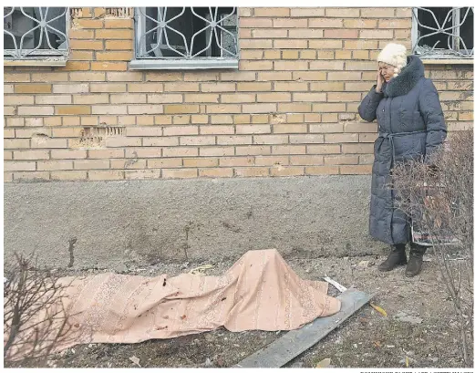  ?? DOMINIQUE FAGET / AFP / GETTY IMAGES ?? A woman cries near the body of her son, killed during shelling at the hospital in Donetsk, Ukraine. European leaders are in Kyiv with a peace plan and NATO formed a force of 5,000 soldiers in response to Russia’s increasing military presence.