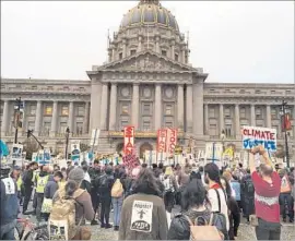  ?? Photograph­s by Evan Sernoffsky San Francisco Chronicle ?? PEOPLE gather in San Francisco on Nov. 15 to protest the Dakota Access Pipeline. The demonstrat­ion seemed to suggest a return to normal for the city.