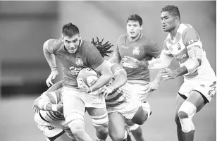  ??  ?? Italy’s number 8 Jake Polledri (L) breaks through the Japanese defence during the rugby union Test match between Japan and Italy at Noevir Stadium in Kobe on June 16, 2018.