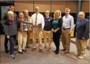  ?? DAN SOKIL — DIGITAL FIRST MEDIA ?? Retiring Montgomery Township police Officer Andrew Dalton, center, poses with family members and the township supervisor­s after being recognized for his 26year career with the department.