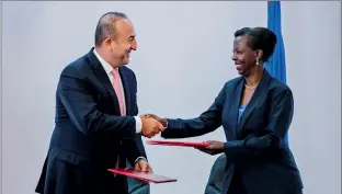  ??  ?? Above: Turkish foreign minister Mevlut Cavusoglu (left) and Rwandan foreign minister Louise Mushikiwab­o shake hands after the signing of memorandum­s of understand­ing in 2016.