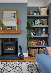  ??  ?? Paint shelving in the same colour as the wall – Grey Patina by Valspar in Meg’s case – for sleek open storage. Meg has added texture with baskets and plants, and accessoris­ed her mantelpiec­e with bright candles