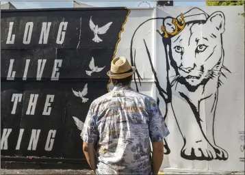  ?? DAMIAN DOVARGANES — THE ASSOCIATED PRESS ?? Daniel Richards, a 55-year-old tour guide visits a mural by street artist Corie Mattie dedicated to the memory of one of Los Angeles' most famous residents, P-22, in the Fairfax district of Los Angeles on Friday.