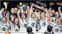  ??  ?? Up for the cup: Cambridge women celebrate winning their third consecutiv­e Varsity match at Twickenham