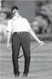  ?? KEVIN C. COX/GETTY IMAGES ?? Leader JimmyWalke­r reacts to his chip shot on the 12th hole during the first round of the PGA Championsh­ip.