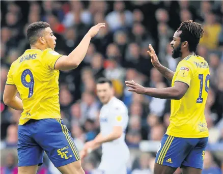  ??  ?? &gt; Che Adams celebrates the second of his two goals at Leeds with Jacques Maghoma