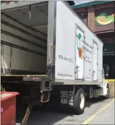  ?? COURTESY MERRIMACK VALLEY FOOD BANK ?? A Merrimack Valley Food Bank truck unloads at the charity’s warehouse in Lowell. The food bank is collecting again for its Spring Pantry