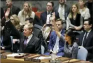  ?? THE ASSOCIATED PRESS ?? Matthew Rycroft, left, Britain’s Ambassador to the U.N. and U.S. Ambassador Nikki Haley vote in favor of a resolution, Friday, Dec. 22, 2017, at United Nations headquarte­rs. The council is voting on proposed new sanctions against North Korea, including sharply lower limits on its refined oil imports, the return home of all North Koreans working overseas within 12 months, and a crackdown on the country’s shipping.