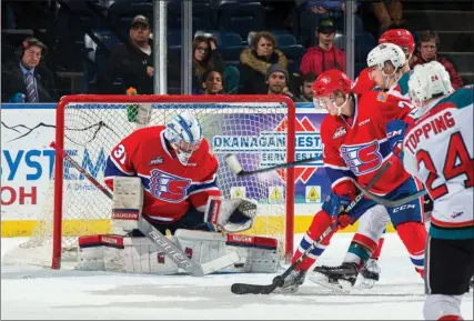  ?? MARISSA BAECKER/ Shoot the Breeze ?? Goalie Bailey Brkin of the Spokane Chiefs makes a third-period save against Kyle Topping and the Kelowna Rockets in WHL play at Prospera Place on Wednesday night. The Chiefs won 6-5 in overtime.