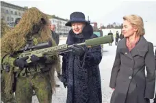  ?? MINDAUGAS KULBIS, AP ?? German Defense Minister Ursula von der Leyen, right, and Lithuania’s President Dalia Grybauskai­te speak with a soldier during the NATO Enhanced Forward Presence battalion welcome ceremony on Tuesday, west of the capital Vilnius.