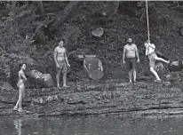  ?? ADAM EWING/FOR THE WASHINGTON POST ?? A family hangs out at the water’s edge near the Big Bend Campground, an off-the-grid camping spot in the Smoke Hole Canyon in Monongahel­a National Forest.
You can board the Durbin Rocket, a steam train that drops off you and your fully renovated Wabash Railroad caboose (with bathroom facilities and fridge and cooking area) in a remote area by the Greenbrier River, with no cell service. The caboose holds up to six people. $330 for first night, $225 for second night, $190 for third night. 304-636-9477. mountainra­ilwv.com.
The park has four-person Legacy cabins that range from $109 to $119 per night Sunday through Thursday, $119 to $139 on Friday and Saturday. There are also Legacy cabins for two, three, six and eight people. There are 11 other Classic or Vacation cabins with more modern constructi­on that are available yearround. Cell service is unreliable; cabins are wired for WiFi (though if the password ends up in the campfire, so be it). 304-897-5372. wvstatepar­ks.com.
This seriously off-the-grid campground in the gorgeous Smoke Hole Canyon in Monongahel­a National Forest is a favorite for fishing — it sits by the South Branch of the Potomac River — and hiking. Its 46 sites are available from April through late October. Camping fees range from $22 to $40 a night, with bathroom and shower facilities. 877-444-6777. recreation.gov.