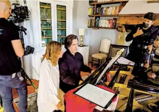  ?? COURTESY OF HERSHEY FELDER ?? Hila Plitmann and Hershey Felder film a scene from “Dante and Beatrice in Florence,” which was filmed in Florence, Italy. It will be co-presented by San Diego Rep virtually at 5 p.m. today.