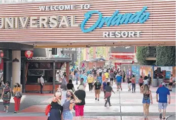  ?? STEPHEN M. DOWELL/ORLANDO SENTINEL ?? Guests walk along Universal CityWalk on May 14, where Universal began limited operations of select venues.