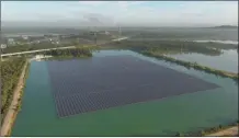  ?? AP photo ?? An array of solar panels float on May 3, in Selangor, Malaysia. Floating solar panel farms are beginning to boom in the United States after rapid growth in Asia. They’re attractive not just for their clean power and lack of a land footprint, but because they also conserve water by preventing evaporatio­n.