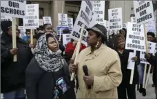  ?? PHOTO/CARLOS OSORIO ?? In this Feb. 17 photo, Roquesha O’Neal (left), and Shoniqua Kemp participat­e in a rally in Detroit. AP