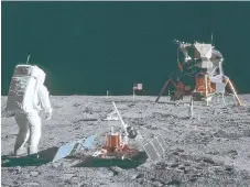 ??  ?? Buzz Aldrin sets up an experiment on the moon’s surface.