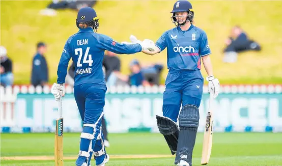  ?? Photo / Photosport ?? Charlie Dean (left) and Amy Jones fashioned a winning partnershi­p for England in Wellington on Monday.