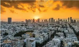  ?? ZZ3701/Getty Images/iStockphot­o ?? To be seen clearly it must be viewed from afar … sunrise over Tel Aviv. Photograph: