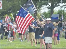  ??  ?? Police supporters wave flags at the ‘Back the Blue’ rally along MacDade Boulevard in Ridley Sunday.