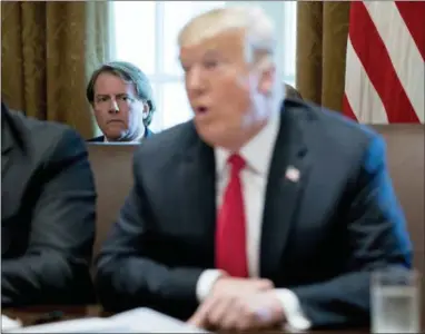  ?? THE ASSOCIATED PRESS ?? White House counsel Donald McGahn, left, listens as President Donald Trump speaks during a cabinet meeting Thursday in the Cabinet Room of the White House in Washington.